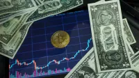 Bitcoin coin on a tablet showing stock chart, surrounded by dollar bills.