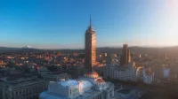 Skyline featuring Torre Latinoamericana in Mexico City during sunset, showcasing urban architecture.