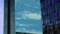 High-rise building with reflective glass windows showcasing a modern architectural style.
