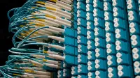 From below of fiber optic equipment with similar colorful rubber cables and round sockets