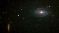 A captivating view of a spiral galaxy surrounded by thousands of stars in the night sky.