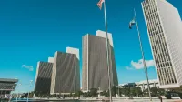 Modern skyscrapers towering at Empire State Plaza in Albany, New York under a clear blue sky.