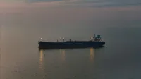 Oil tanker 'Northsea Shipping' sailing on calm waters during twilight, reflecting a serene scene.