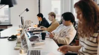Young professionals working collaboratively in a modern office environment, fostering teamwork and innovation.