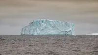 Stunning view of a massive iceberg in Antarctica, symbolizing the beauty and fragility of polar environments.