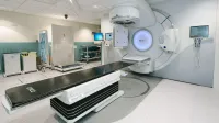 High-tech radiotherapy machine in a hospital's clinical setting for patient treatment.