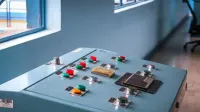 Close-up of an industrial control panel with colorful buttons in a factory setting.