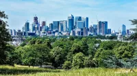 Stunning view of London skyline with greenery from Greenwich Park.