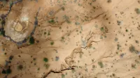 Aerial view capturing the arid, cracked terrain of Kimanjo, Laikipia County, Kenya.