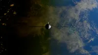 A satellite orbiting Earth showcasing contrasts between ocean and land from space.
