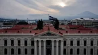 Aerial view of the Palacio Nacional in San Salvador, El Salvador, under a dramatic sky.