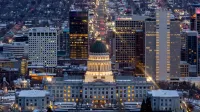 A breathtaking view of Salt Lake City's skyline illuminated at night, featuring the Utah State Capitol.