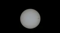 Close-up image of the sun with visible sunspots on a black background.