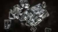 Macro shot of clear crystal cubes showcasing intricate details and textures.