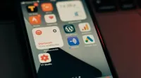 Close-up view of smartphone screen featuring various app icons and notifications.