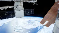 A mesmerizing view of Earth as seen from a space station with solar panels and satellite modules.
