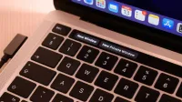 A detailed view of a laptop keyboard with browser tabs open, highlighting 'New Window' and 'New Private Window'.