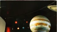 A model of the solar system with planets is on display at a science museum.