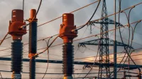 Detailed view of power transformers and lines against a sunset sky in Austria.