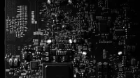 Detailed black and white photo of a circuit board showing intricate components, perfect for tech projects.