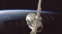 A satellite orbiting Earth with a view of the planet from space.
