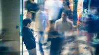 Blurred motion of people walking in Kowloon, Hong Kong, capturing urban life and activity.