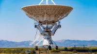 Close-up of a large radio telescope at the VLA, Socorro, New Mexico, against a clear blue sky.