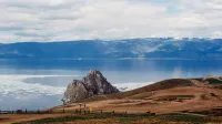 Breathtaking scenic view of Lake Baikal with rugged cliffs and clear waters in a serene landscape.