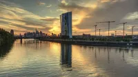 Stunning view of the Frankfurt skyline and ECB building during sunset reflecting on the Main River.