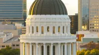 Majestic view of the California State Capitol Dome in Sacramento during sunset with clear skies.