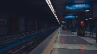 A dimly lit metro station platform with passengers waiting, showcasing urban public transportation.