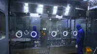 Workers in protective gear inside a sterile pharmaceutical manufacturing plant in Rawalpindi, Pakistan.