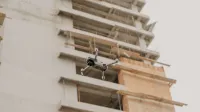 Aerial drone in flight near a construction site in urban Guatemala.