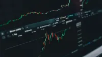 Close-up of a digital market analysis display showing Bitcoin and cryptocurrency price trends.