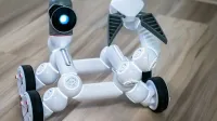 Close-up of a modern wheeled robot with a blurred background, indoors.