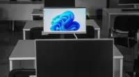 A contemporary office setup featuring computers on desks with modern flat screens.