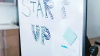 Creative startup concept handwritten on a whiteboard, symbolizing innovation in business.