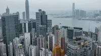 Elevated view of Hong Kong's modern skyscrapers and Victoria Harbor.