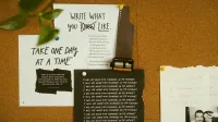 A corkboard with motivational quotes, notes, and film negatives, fostering creativity and reflection.