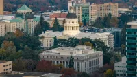 Stunning aerial view of the iconic California State Capitol in Sacramento surrounded by cityscape.
