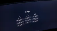 Close-up of a computer screen displaying ChatGPT interface in a dark setting.