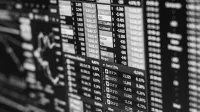 Monochrome image of stock market data on a screen, depicting financial information and trends.