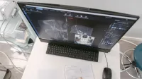 Radiologist analyzing X-ray scans on a computer monitor while taking notes. Medical documents visible.