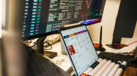 A sleek, modern workspace featuring trading monitors and a tablet for project management.