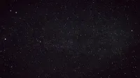 A clear starry night sky captured over the countryside in Germany, showcasing countless stars.