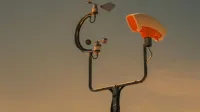 Weather monitoring equipment with a sunset sky backdrop, highlighting technology and atmosphere.