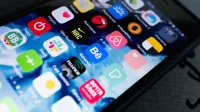 Detailed view of smartphone displaying multiple app icons on screen, highlighting technology use.
