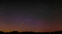 Long exposure of star trails in the night sky above rural Hamburg, Germany.