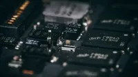Detailed macro shot of electronic circuit components showcasing intricate design and layout.