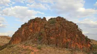 Explore the dramatic rock formations of Australia's Northern Territory under a vibrant sky.